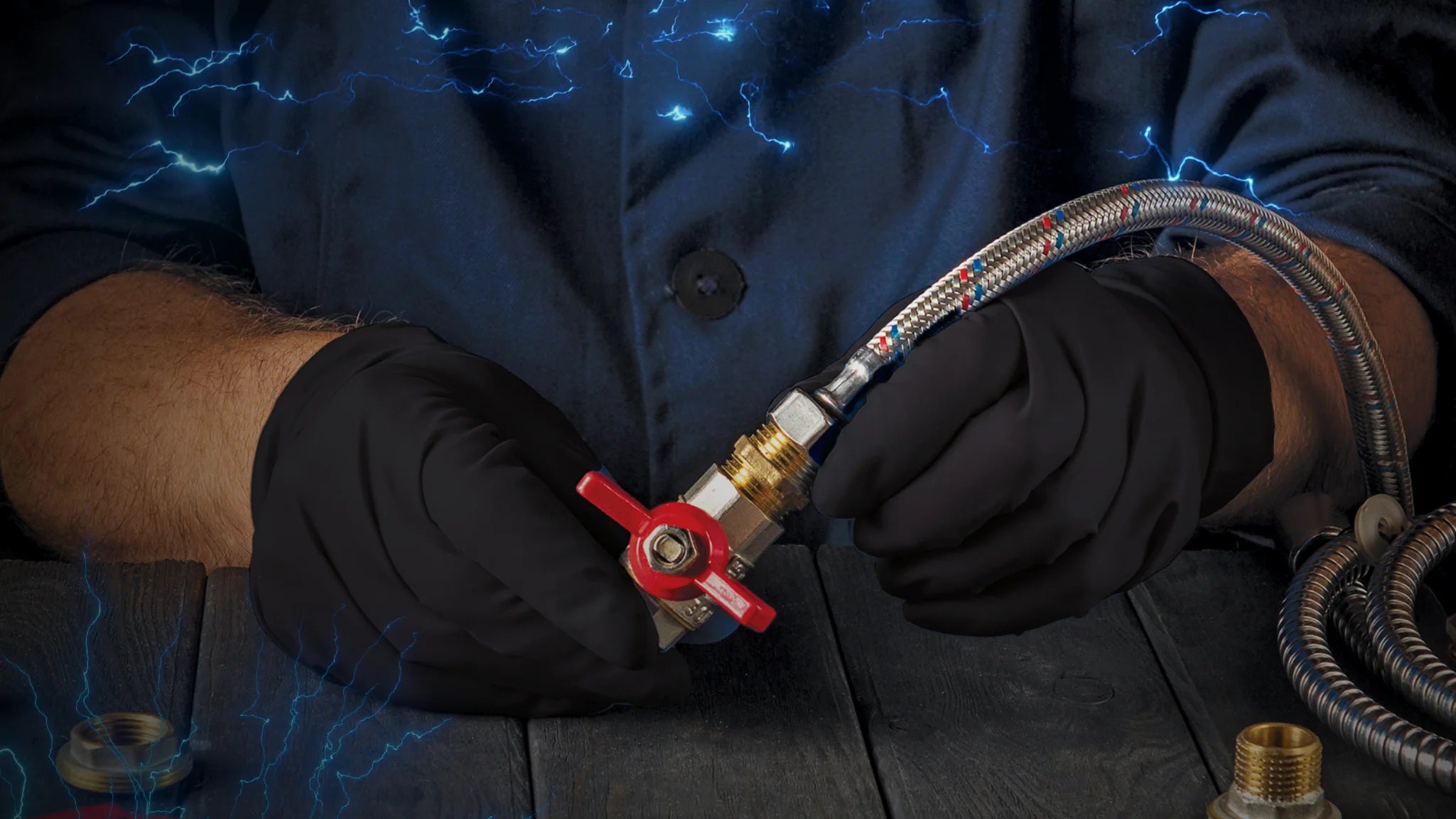 hands wearing black nitrile gloves holding plumbing parts