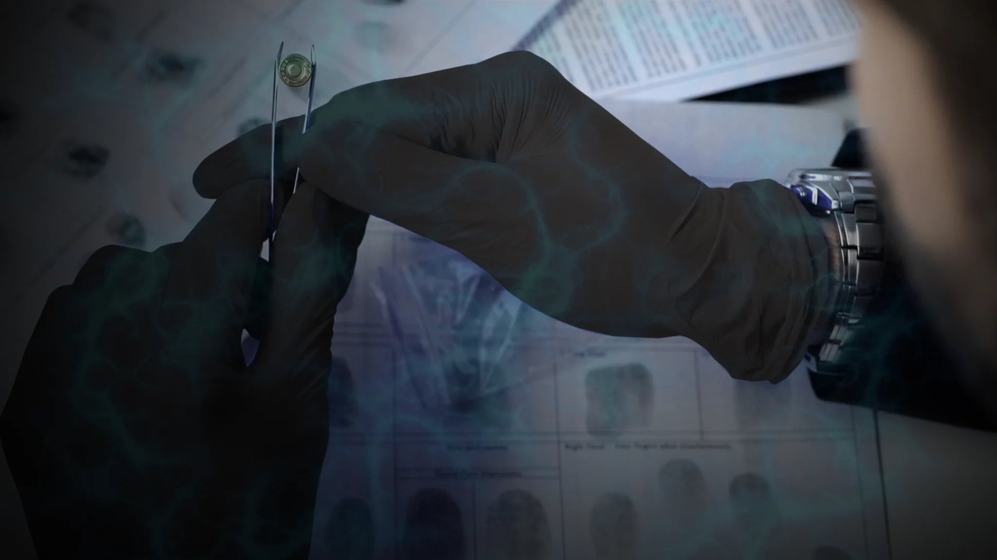 law enforcement officer wearing black nitrile gloves holding a bullet as an evidence