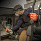 Plumber using 8 mil Orange-Nitrile gloves